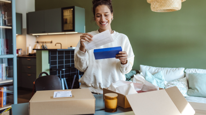 woman-opening-box-from-subscription-based-business-model